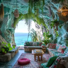 a living room filled with lots of furniture next to an ocean side wall covered in plants