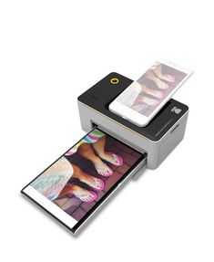 an image of someone's feet on a printer with their phone in the background