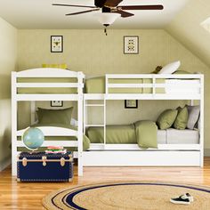 a bedroom with two bunk beds and a rug on the floor in front of it