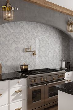 a kitchen with an oven, stove and counter tops in white and grey colors is pictured