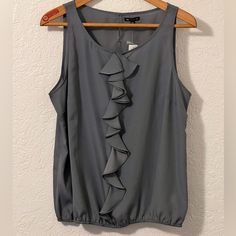 Women’s Sleeveless Blouse From Gap. Nwt Xxl But Fits More Like And Xl. Would Look Great Under A Blazer. Ruffles Down The Front And Elastic On The Bottom Armpit To Armpit 23” Length 26” Gray Gap Sleeveless Tank Top For Summer, Sleeveless Gap Tank Top For Summer, Gap Ruffled Tops For Summer, Gap Sleeveless Summer Camisole, Chic Sleeveless Tops By Gap, Chic Sleeveless Gap Tops, Summer Ruffled Tops By Gap, Summer Ruffled Tops From Gap, Elegant Sleeveless Gray Tops