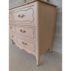 an old dresser has been painted pink and gold