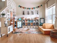 a living room filled with lots of furniture and decor on top of hard wood floors