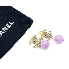 Chanel Gold CC Lavender Stone Clip on Earrings  * Marked 10 ( Missing one stamp) * Made in France * Comes with original dustbag  -Approximately 1.25″ x 0.6″ -Very classic and pretty -In a very good condition  3130-45352  Please see the measurements section for best approximate dimensions. Luxury Purple Earrings For Evening, Luxury Purple Round Earrings, Luxury Lavender Jewelry As A Gift, Prada Jewelry, Lavender Stone, Gold Ounce, Balenciaga Designer, Stamp Making, Beaded Dangles