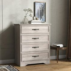 a white dresser sitting next to a window in a room with wooden floors and walls