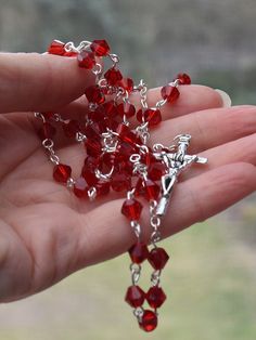 A beautiful five decade Rosary handmade with red cristal glass beads. Rosary circuit - 27,5 inches (70cm), which makes this perfect to pray with as well as wear around your neck. Features The crucifix measures 1.5 in (4cm) by0.8in (2cm). Beautiful, natural 6mm red glass beads Our Lady Medal Rosary Center Packaged in an organza gift bag. Handmade with love Average delivery times: Europe: 7 days USA: 10 days Handmade Red Rosary For Jewelry Making, Handmade Red Crucifix Jewelry, Spiritual Red Crucifix Rosary, Red Spiritual Rosary As Gift, Faceted Beads Crucifix Rosary As Gift, Handmade Red Rosary With Cross, Red Crucifix Rosary As Gift, Handmade Red Cross Rosary, Handmade Red Rosary