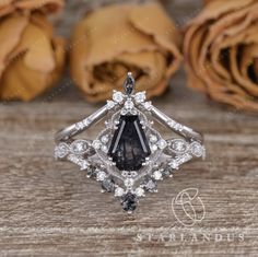 a black diamond ring sitting on top of a wooden table