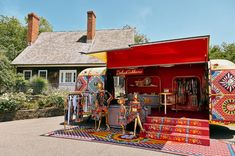 an outdoor area with colorful rugs on the ground