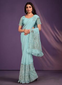 Experience the ultimate in elegance and luxury with our Sky Blue Organza Georgette Saree. Adorned with intricate sequins, cord thread embroidery, and sparkling stones, this saree is perfect for any party or special occasion. Show your loved one how much you care with this stunning gift for your girlfriend. Includes a blouse for a complete look. The unstitched blouse can be customized upto 42 inches. Do Note: All the accessories shown are for styling purpose only. Slight color variation may occur Blue Bollywood Blouse For Formal Occasions, Blue Bollywood Formal Blouse Piece, Blue Bollywood Style Formal Blouse Piece, Fitted Blue Saree For Party Wear, Blue Party Wear Traditional Outfit With Intricate Embroidery, Blue Party Wear Traditional With Intricate Embroidery, Blue Traditional Wear With Intricate Embroidery For Party, Festive Light Blue Blouse Piece For Party, Formal Blue Bollywood Pre-draped Saree