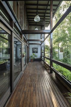 a wooden porch with glass doors and plants