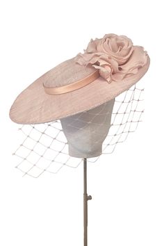 Classically elegant disc hat with flower and veil.‘Aurelia’ is a perfectly proportioned and flattering silhouette to see you through the summer season.From Weddings to the Royal Enclosure at Royal Ascot, a timeless style that is light and comfortable to wear.The soft wire headband discretely keeps the hat in place and is effortless to put on, with no risk of ‘hat hair’. --- Pinokpok base with silk flower and trim. Dye-to-Match Colour service offered for the style. Luxury White Costume Hats And Headpieces For Royal Ascot, Luxury Elegant Hat For Celebration, Luxury Elegant Hats For Women, Luxury Elegant Six-panel Hat, Luxury Formal Hats For Royal Ascot, Luxury Elegant Hats And Headpieces For Royal Ascot, Luxury Elegant Hats For Fall, Luxury White Traditional Hat, Luxury Headband For Royal Ascot