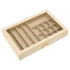 an open jewelry box with multiple compartments on the bottom and inside, sitting on a white surface