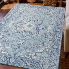 a blue area rug on the floor in a living room