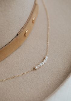 We’re in our Pearl Era, so naturally we made a pearl version of our Linked Necklace. Instead of chain links, let each of these pearls symbolize something special in your life. Use it as a daily reminder to count your blessings. 2-7 pearls are attached to 15" our delicate cable chain with a 1" extender. Available in 14kt Gold Fill + Sterling Silver. Claire layers it with our Nash Lariat Necklace. KJ layers it with our Evermore Necklace and Herra Chain. Handmade in Eau Claire, WI. Our jewelry is h Delicate White Necklace For Everyday Elegance, White Pearl Chain Jewelry For Everyday Elegance, Yellow Gold Pearl Jewelry For Everyday, Yellow Gold Pearl Jewelry For Everyday Elegance, Everyday Elegance Yellow Gold Pearl Jewelry, Classic Everyday Pearl Jewelry, Everyday Elegant Pearl Pendant Jewelry, Dainty White Necklace For Everyday Elegance, White Dainty Necklace For Everyday