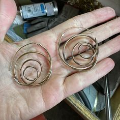 I am always on the quest to figure out a new shape out of a single wire. These whirlwind earrings are made of a looped and fabricated .8mm round wire. They are light, interesting and unique hoop for those people that don't like posts. About 1.75" in diameter, made in brass and finished in 14k nickel free gold plate. You are also welcome to order them in silver! Single Metal Earring With A Modern Twist, Single Earring In Metal With A Modern Twist, Rose Gold Brass Hoop Earrings With Ear Wire, Single Earring With A Modern Twist, Rose Gold Hoop Earrings With Brass, Modern Twist Hoop Earrings In Metal, Spiral Earrings With A Modern Twist, Modern Twist Round Metal Earrings, Modern Twist Nickel Free Hoop Earrings