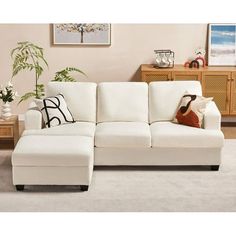 a white couch sitting on top of a rug in a living room