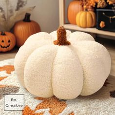 a white pumpkin sitting on top of a rug