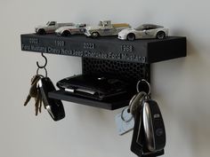 there is a shelf with keys and cars on it