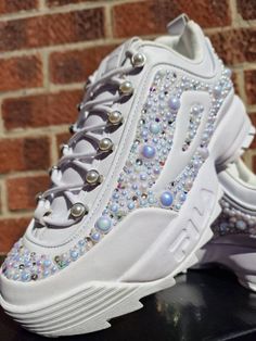 One of a kind Fila Pearl Disrupter trainers/sneakers UK size 7, customised by hand with hundreds of iridescent pearls and swarovski crystals to really give a one of a kind cinderella feel! These would be great for Bride to be, hen party, festival, party or just popping to the shops. Stay sparkley Aimee xx White Custom Rhinestone Sneakers For Streetwear, White Rhinestone Custom Sneakers For Streetwear, White Rhinestones Custom Sneakers For Streetwear, White Custom Sneakers With Rhinestones For Streetwear, Bling Sneakers With Round Toe For Streetwear, White Low-top Custom Sneakers With Bling, High-top Bling Sneakers For Streetwear, Streetwear Sneakers With Rhinestones And Round Toe, White Embellished Sneakers For Streetwear