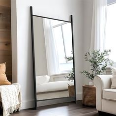 a living room with a couch and a large mirror