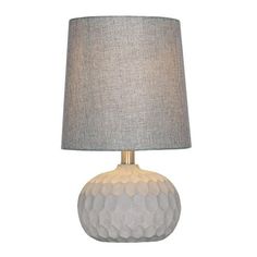 a table lamp with a grey shade on it