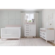 a white crib and dresser in a room