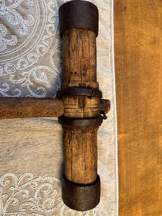 a close up of a wooden object on a bed