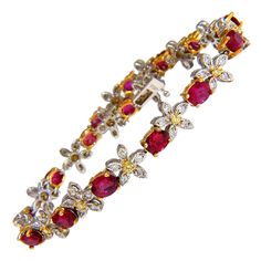 Ruby & Flower Tennis. 6.68ct. Natural ruby bracelet. Oval, full cuts Clean clarity Transparent & Vivid Reds. Average 4 x 5mm each .40ct Natural Diamonds Rounds & full cuts Vs-2 clarity G color .20ct Natural Fancy Yellow Diamonds. 18kt. yellow & white gold 13.8 Grams. 7 inch wearable length 15 ruby count safety clasp/ snap lock $17,000 Appraisal Certificate will accompany. Stone Rings For Men, Ruby Flower, Yule Ball, Bracelet Tennis, Yellow Diamonds, Ruby Bracelet, Fancy Yellow Diamond, Flower Cluster, Snap Lock