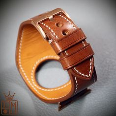 "This Applewatch watchband uses Italian Vegetable tanned leather in Whiskey color and is hand stitched throughout. A soft calfskin lining hugs your wrist and a high quality buckle and applewatch adapters are included. Can be sized for any applewatch! Just supply the series and size ( 38, 40 44mm, etc..) and also the finish ( polished, matte, gold, black, etc..) I'll need your wrist size per the supplied pic. I Can size it for men or women Can be made many finishes and colors. Just ask! - 1-7/8\" Timeless Leather Watch With Bracelet Strap, Modern Brown Watch Accessories With Waxed Finish, Classic Brown Watch With Waxed Finish, Formal Brown Leather Watch Accessories, Modern Brown Watch Bands For Formal Occasions, Modern Brown Watches With Bracelet Strap, Timeless Leather Watch Bands, Brown Leather Bracelet For Formal Occasions, Classic Vintage Brown Watch Bands