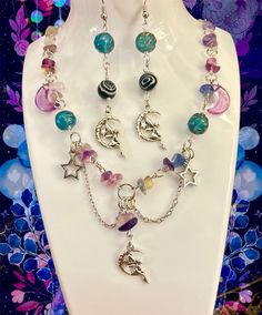 Whimsical Fairy Moon Jewelry Set Glass beads, Dangle Earrings. Whimsigothic Style 🚚 𝔸𝕝𝕨𝕒𝕪𝕤 𝕗𝕣𝕖𝕖 𝕤𝕙𝕚𝕡𝕡𝕚𝕟𝕘! 🌸 𝐻𝒶𝓃𝒹𝓂𝒶𝒹𝑒 𝓌𝒾𝓉𝒽 𝓁𝑜𝓉𝓈 𝑜𝒻 𝓁𝑜𝓋𝑒 💕 🛍️ https://pinkfairymoonshop.etsy.com ✨𝙵𝚛𝚎𝚎 𝚜𝚞𝚛𝚙𝚛𝚒𝚜𝚎 𝚐𝚒𝚏𝚝 𝚊𝚗𝚍 𝚌𝚞𝚝𝚎 𝚜𝚝𝚒𝚌𝚔𝚎𝚛𝚜 𝚠𝚒𝚝𝚑 𝚎𝚟𝚎𝚛𝚢 𝚙𝚞𝚛𝚌𝚑𝚊𝚜𝚎✨ ♡Shipping Info♡ I usually ship the next day with USPS. Tracking info is available on Etsy, US orders usually arrives in 2-3 days after being shipped. ♡ Packaging Details ♡ Al Fairycore Beaded Jewelry For Festivals, Fairycore Beaded Festival Jewelry, Festival Fairycore Beaded Jewelry, Bohemian Halloween Jewelry With Round Beads, Handmade Multicolor Fairycore Jewelry, Fairy Grunge Handmade Festival Jewelry, Handmade Whimsical Jewelry For Cosplay, Whimsical Handmade Jewelry For Cosplay, Whimsigothic Style