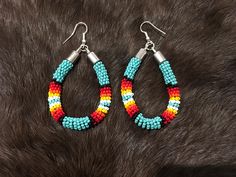 Authentic Beautiful Native American Indian Jewelry Navajo Zuni Hand Beaded  2 3/8inch Hoop Earrings Handcrafted by Navajo Artist Harriet Crosby Great for a  Gift❤️ Present in virtually every Native American tribe, the feather symbol is universally recognized as a representation of trust, strength, wisdom, freedom, and honor. Incorporated into many sacred pieces of Native American wear, the feather is easily one of the most respected symbols. Southwestern Style Round Bead Earrings For Festivals, Southwestern Style Earrings With Round Beads For Festivals, Southwestern Style Beaded Dangle Hoop Earrings, Southwestern Style Earrings With Colorful Beads, Southwestern Multicolor Round Bead Earrings, Multicolor Southwestern Teardrop Jewelry, Southwestern Multicolor Teardrop Beaded Earrings, Multicolor Southwestern Style Teardrop Jewelry, Southwestern Style Multicolor Teardrop Jewelry