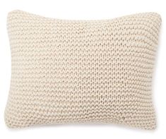 a white knitted pillow on a white background