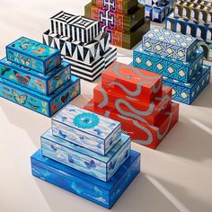 many colorful boxes are stacked on top of each other and one has a decorative design