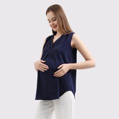 A pleat front maternity blouse is a stylish and comfortable choice for pregnant women. This blouse is made from pearl chiffon that is lightweight and moves with the body, allowing for ease of movement during pregnancy. This blouse can be dressed up with slacks and heels for a chic office look, or kept casual with jeans and sneakers. It is a versatile and practical choice for any stage of pregnancy and can be worn after pregnancy as well.  STYLE: PRBL-SS-VN- Relaxed fit-Â Hits at hipAvailable in Blouse For Office, Maternity Blouses, Pregnant Dress, Formal Top, Formal Tops, Maternity Blouse, Maternity Shirt, Pregnancy Wardrobe, Office Dress