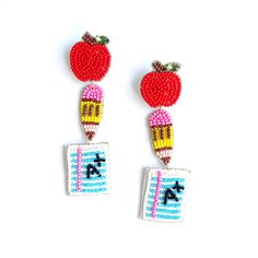 two red and yellow earrings with an apple on top of each earring, one in the