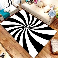 a black and white rug in the middle of a living room next to a couch