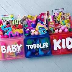 three plastic containers filled with toys on top of a wooden floor next to each other