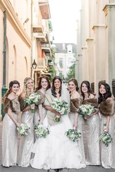 a bride and her bridesmaids posing for a photo