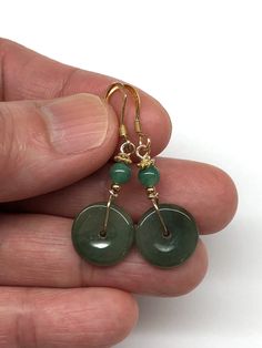 A pair of dangling earrings with a beautiful dark green jade disc safety buckles (平安扣), complemented by green aventurine beads.  The two dark green jade discs are small safety buckles. The Chinese safety buckle (平安扣) is shaped like a coin. The Chinese believed that money brought luck and safety, but wearing a coin was not attractive, so the lucky buckle was designed with materials like jade and agate to wear coins on their person. - made with jade discs, aventurine beads, gold-plated sterling si Green Jade Earrings For Pierced Ears, Nickel-free Round Jade Earrings, Nickel-free Round Jade Jewelry, Jade Dangle Earrings For Pierced Ears, Dark Green Round Jade Jewelry, Jade Dangle Earrings Jewelry Set, Green Aventurine Dangle Earrings, Dangle Jade Earrings With Matching Set, Jade Dangle Earrings With Matching Set