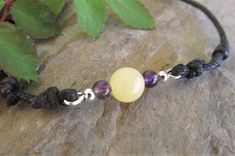 This very cute anklet features an 8mm yellow jade bead accented with 6mm amethyst beads on 1.5mm waxed cotton cord finished with double slider knots making this anklet fully size adjustable down to a minimum of 8 inches. Comfortable, sturdy and easy to wear this style would make a great gift idea. YELLOW JADE SYMBOLISM AND PROPERTIES Yellow jade is said to be a stone of wisdom, helping users to learn from their experiences and gain self-confidence. Yellow as a color also symbolizes warmth and joy. This stone is also believed to affect the digestive system and increase the metabolism and resonates with the solar plexus chakra. Adjustable Spiritual Waxed Cord Jewelry, Spiritual Jewelry With Natural Stones On Waxed Cord, Spiritual Jewelry With Natural Stones And Waxed Cord, Bohemian Waxed Cord Beaded Jewelry, Adjustable Waxed Cord Jewelry For Everyday, Beaded Waxed Cord Bracelet, Minimalist Adjustable Jewelry For Meditation, Adjustable Jewelry With Natural Stones And Waxed Cord, Handmade Minimalist Jewelry With Waxed Cord