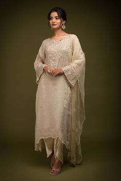 Ivory and beige kurta with cutdana embroidered floral jaal patterns embellished by mirrorwork. Comes with dhoti pant, inner and dupatta. - Aza Fashions Festive Slub Silk Kurta With Naqshi, Off White Raw Silk Sets With Traditional Drape, Designer Cream Sets With Traditional Drape, Elegant Wedding Palazzo Set With Naqshi, Festive Beige Sets With Traditional Drape, Festive Slub Silk Salwar Kameez With Naqshi, Naqshi Cotton Silk Salwar Kameez For Wedding, Cotton Silk Salwar Kameez With Naqshi For Wedding, Festive Naqshi Slub Silk Salwar Kameez