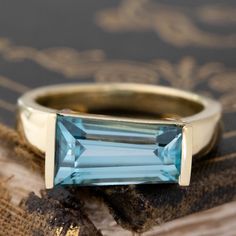 a ring with an aqua topazte stone on it