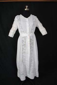 "EDWARDIAN LINEN DAY DRESS, 1915-1920 An Edwardian white medium weight linen dress, one piece in construction. This dress is for a tall woman. Large sailors collar attached at neckline accented with fancy machine lace. Attached belt at back with two large crochet covered buttons at back. 3/4 full sleeves with machine lace on cuffs. Accented with machine lace inserts starting at front bodice neckline extending downward into waist, then into skirt ending with double rows of lace inserts circling t Historical Prairie Dress For Daywear, Victorian White Daywear Dress, Victorian Empire Waist Dress For Daywear, White Victorian Daywear Dress, Elegant Prairie Dress With Historical Design, Classic Vintage Dress For Daywear, Victorian White Dress For Daywear, White Victorian Dress For Daywear, White Historical Dress For Daywear