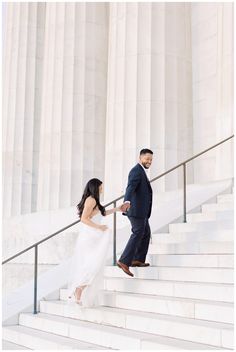 a bride and groom walking down the stairs at the lincoln memorial