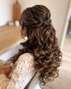 a woman with long hair sitting in a chair