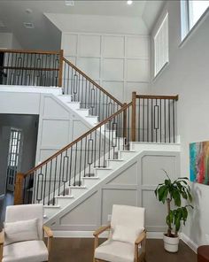 a living room filled with furniture and a stair case