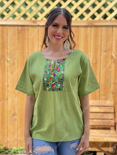 This Beautiful Hand embroidered blouse has a unique and Mexican inspired Floral design. The blouse has a beautiful traditional look to it and is made with fresh Mexican linen. The Jewelry modeled may be purchased here: Filigree Earrings: https://www.etsy.com/es/listing/872372628/filigrana-clasica-de-gota-arete-mexicano?ref=listings_manager_grid Traditional Green Blouse For Spring, Traditional Green Cotton Tunic, Traditional Summer Kurta For Ceremonies, Traditional Cotton Tunic With Embroidered Neckline, Green Bohemian Tops With Intricate Embroidery, Bohemian Green Blouse With Floral Embroidery, Traditional Spring Tunic Blouse, Bohemian Green Tops With Intricate Embroidery, Green Bohemian Top With Intricate Embroidery