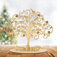 an ornament with the words family on it and a christmas tree in the background