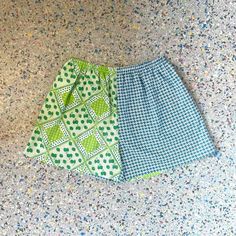 "Up cycled, repurposed, vintage fabric. Green and Blue Strawberry Print, mixed with a Blue and White print Size: XL Waist 31\" stretches to 52\"  Hips 54\"  Rise 14.5\" Inseam 4.5\" High waisted fit, contrasting side seam pockets. Elastic waist band .  Cotton, poly .  *fabric is repurposed may have slight wear . Each of these shorts are one of a kind with unique placement of fabric and colors.         From the Kiki42 label, handmade in Los Angeles CA." Upcycled Blue Bottoms For Spring, Green Cotton Bottoms For Daywear, Green Patchwork Bottoms For Vacation, Blue Cotton Upcycled Bottoms, Upcycled Cotton Blue Bottoms, Blue Upcycled Cotton Bottoms, Upcycled Blue Cotton Bottoms, Summer Green Shorts With Patchwork, Green Cotton Retro Shorts