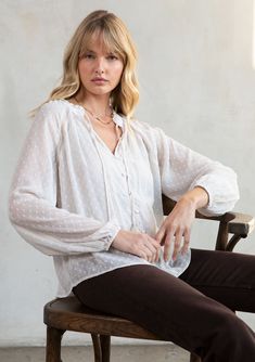 Light-as-air swiss dot chiffon adds an ethereal quality to this classic bohemian blouse. Inspired by some of our favorite vintage pieces, this effortless style features lace trim inserts, a self-covered button front, and playful tassel ties. FINAL SALE Swiss dot chiffon Relaxed fit Long voluminous sleeve Elastic wrist cuff Ruffled neck V-neckline with tassel ties Self-covered button front Lace trim inserts Sheer Removable lining Dreamy bohemian peasant blouse Model is 5'9, wearing a size S.Style Affordable Relaxed Fit V-neck Blouse, Casual Swiss Dot Blouse For Daywear, White Swiss Dot Top For Fall, Feminine Blouse With Lace Trim For Layering, Feminine Long Sleeve Blouse With Swiss Dot, Casual Swiss Dot Blouse For Fall, Fall Flowy Blouse With Lace Trim, Flowy Lace Trim Blouse For Fall, Elegant Swiss Dot Top For Daywear